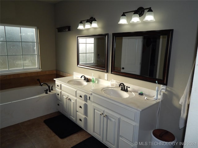 bathroom with vanity, a tub to relax in, and tile patterned floors