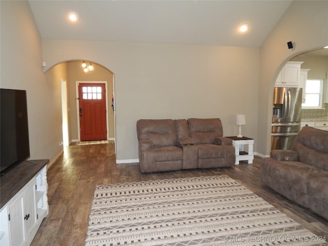 living room with dark hardwood / wood-style flooring and lofted ceiling