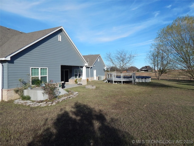 2270 E 154th St, Skiatook, OK 74070 - rear view of property with a lawn, a wooden deck, a shingled roof, and central AC unit