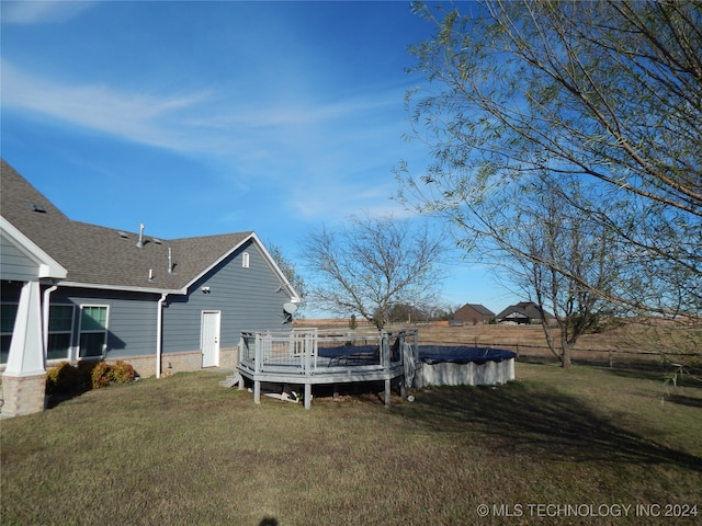 exterior space with a lawn and a swimming pool side deck