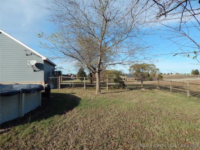 view of yard featuring a rural view and a covered pool