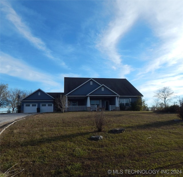 2270 E 154th St, Skiatook, OK 74070 - view of front of home featuring asphalt driveway, a garage, covered porch, and a front lawn