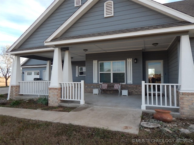 2270 E 154th St, Skiatook, OK 74070 - view of front of house with a porch, brick siding, and a shingled roof