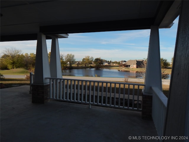 view of patio / terrace with a water view and covered porch