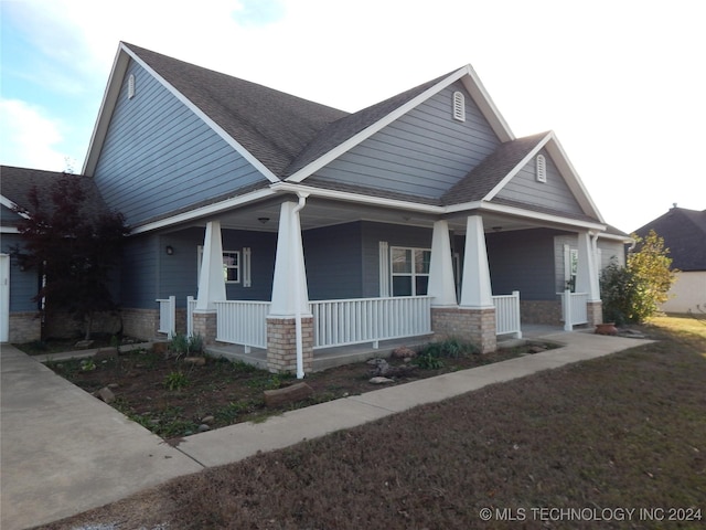 2270 E 154th St, Skiatook, OK 74070 - craftsman-style home with roof with shingles, covered porch, and stone siding