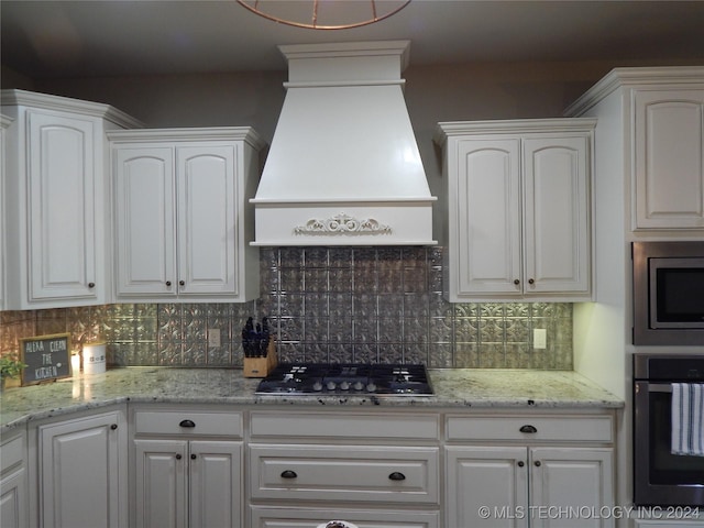 kitchen featuring custom exhaust hood, white cabinetry, and stainless steel appliances