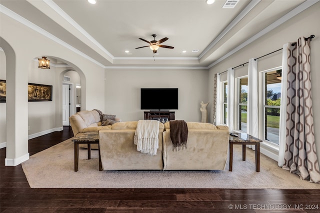 living room featuring a tray ceiling, ceiling fan, and wood-type flooring