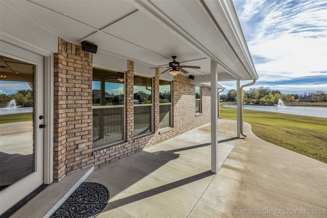 view of patio / terrace featuring ceiling fan and a water view