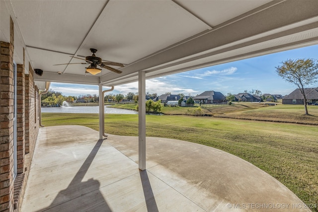 view of patio featuring ceiling fan and a water view