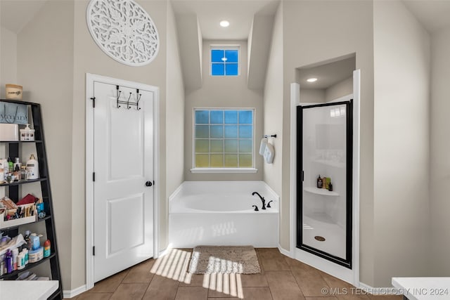 bathroom with tile patterned flooring and shower with separate bathtub