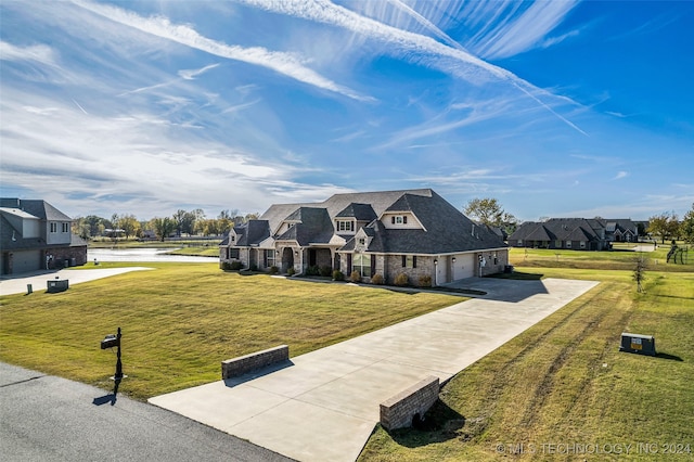 view of front of home featuring a garage and a front yard