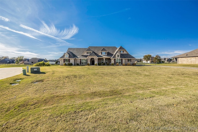 french country inspired facade featuring a front yard