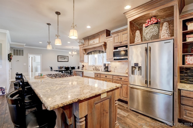 kitchen with decorative backsplash, a kitchen island, wood-type flooring, and appliances with stainless steel finishes