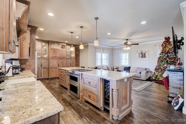 kitchen featuring dark hardwood / wood-style flooring, range with two ovens, a kitchen island, and light stone counters