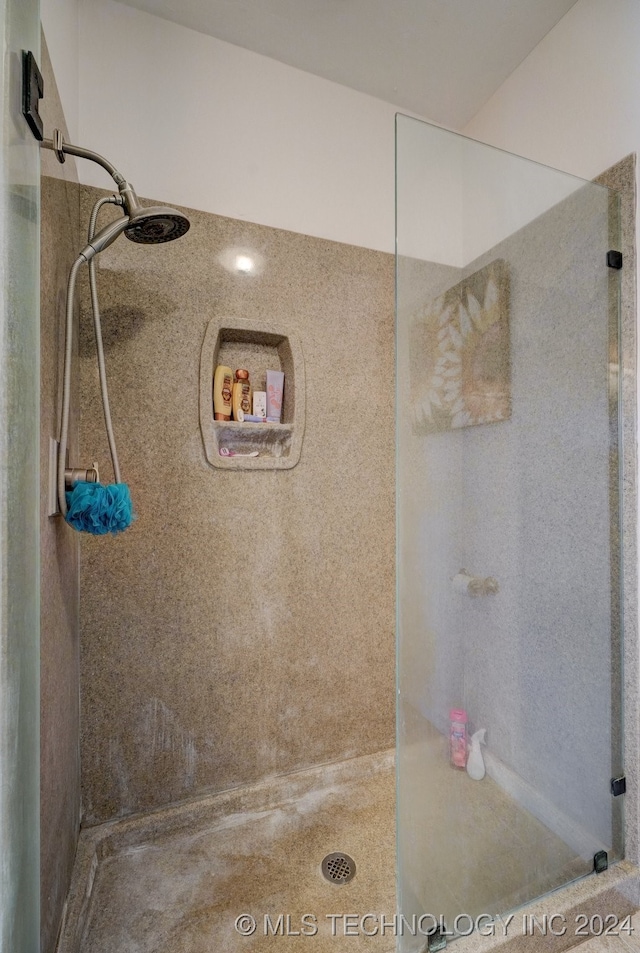 bathroom with a tile shower