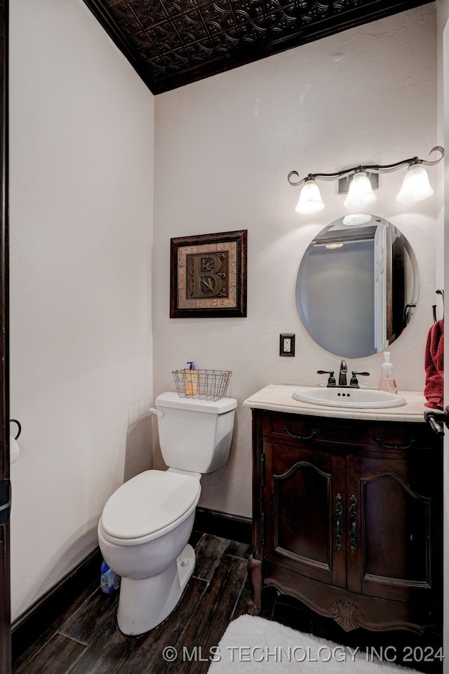 bathroom featuring hardwood / wood-style floors, vanity, and toilet