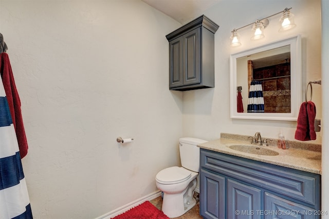 bathroom with vanity, toilet, and walk in shower