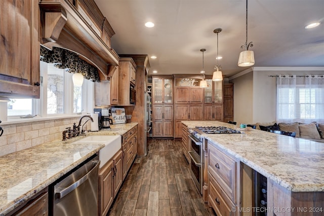 kitchen featuring a center island, dark wood-type flooring, stainless steel appliances, tasteful backsplash, and crown molding