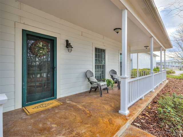 view of exterior entry featuring a porch