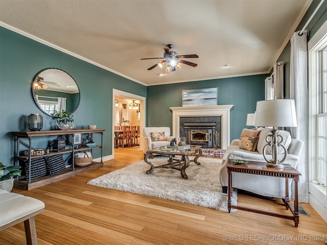 living room with ceiling fan, ornamental molding, a healthy amount of sunlight, and hardwood / wood-style flooring