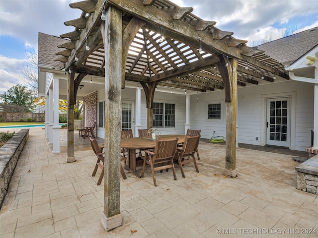 view of patio / terrace featuring a pergola and a swimming pool