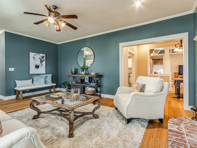 living room with hardwood / wood-style floors, ceiling fan, and crown molding