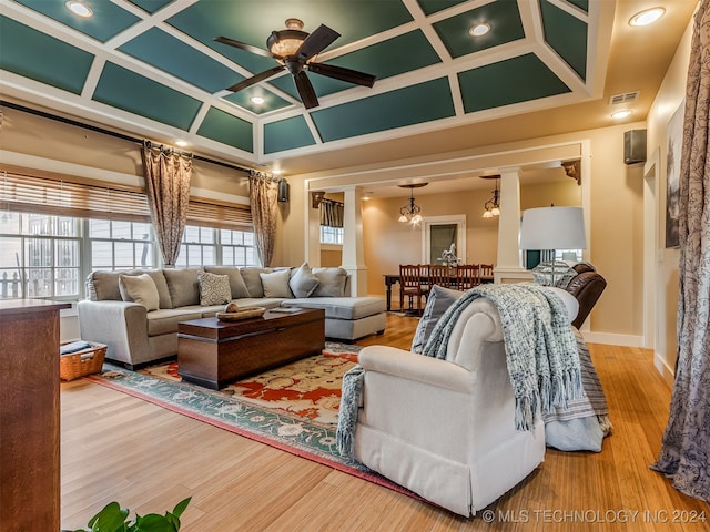 living room featuring wood-type flooring, ceiling fan, and coffered ceiling