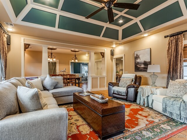 living room with a wealth of natural light, coffered ceiling, and hardwood / wood-style flooring