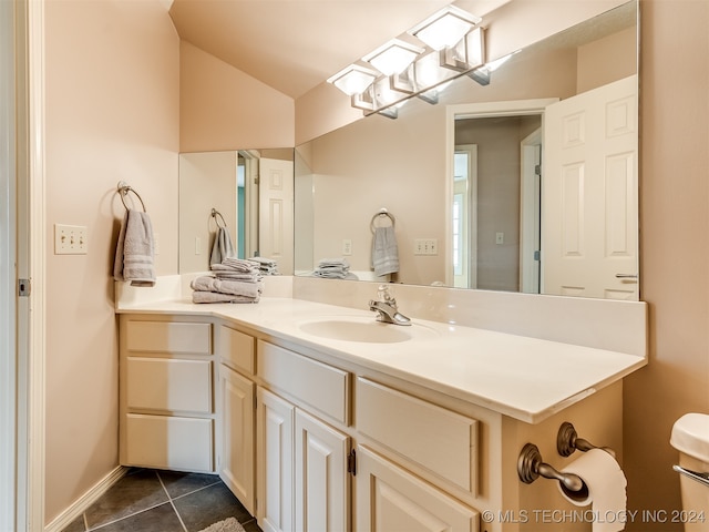 bathroom featuring tile patterned flooring and vanity