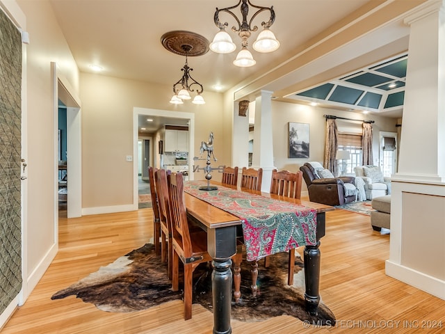 dining room with a chandelier and light wood-type flooring