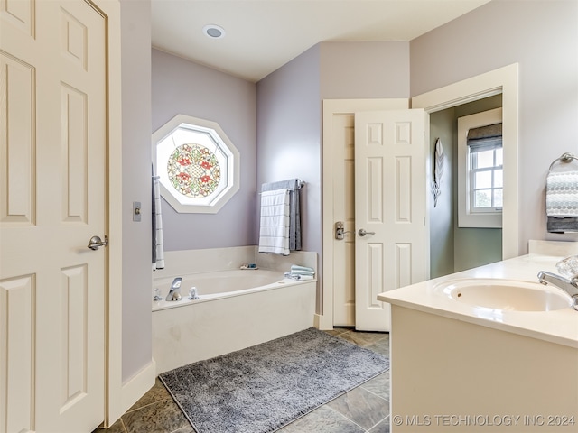 bathroom featuring a tub and vanity