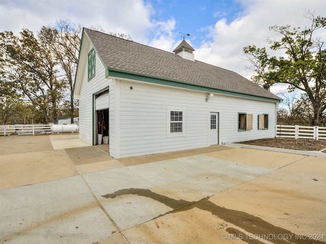 exterior space featuring an outbuilding, a garage, and a patio area