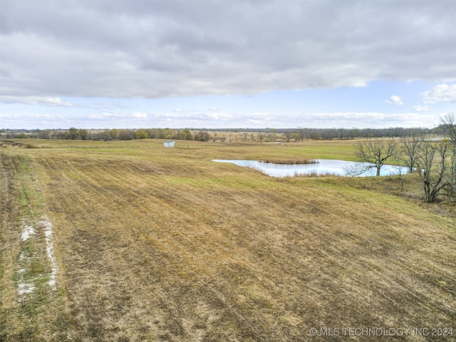 exterior space with a rural view and a water view