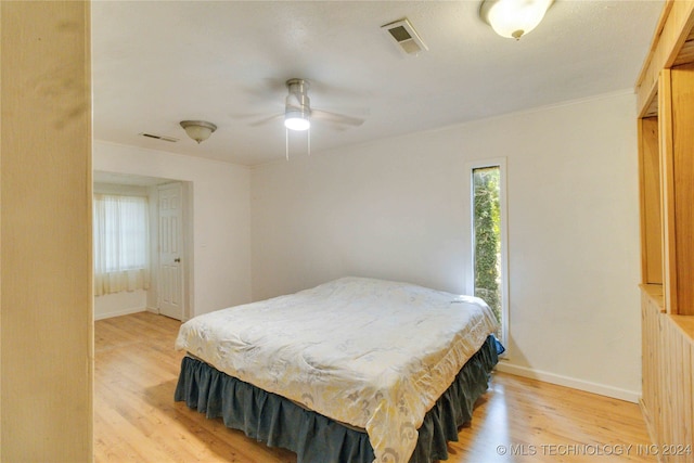 bedroom with light hardwood / wood-style flooring and ceiling fan