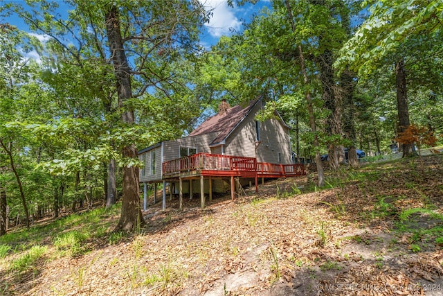 back of house with a wooden deck