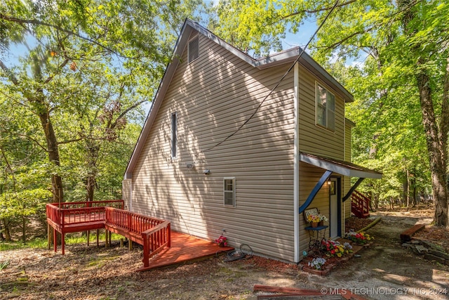 view of property exterior featuring a deck