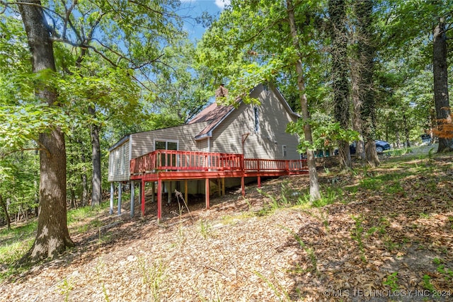 back of house with a wooden deck