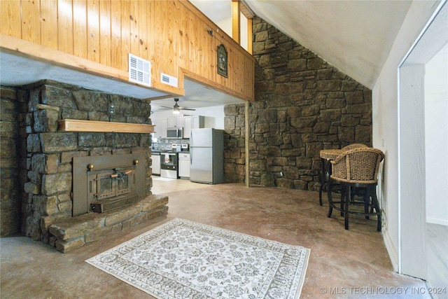 living room with ceiling fan and vaulted ceiling