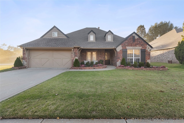 view of front of property with a garage and a front yard