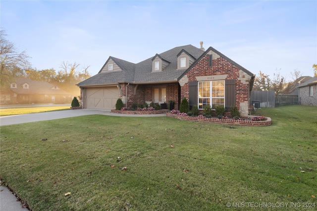 view of front of house with a front lawn and a garage