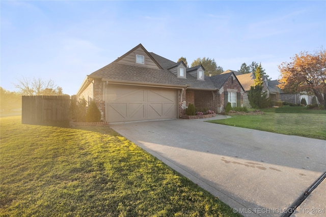 view of front of property featuring a front lawn and a garage