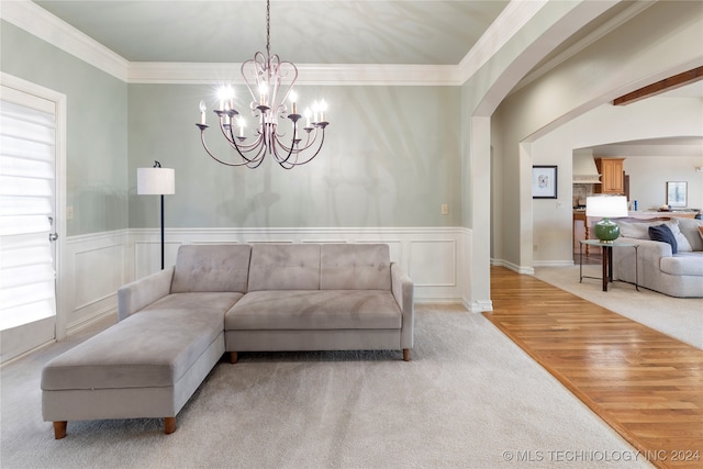 living room featuring crown molding, plenty of natural light, and light hardwood / wood-style floors