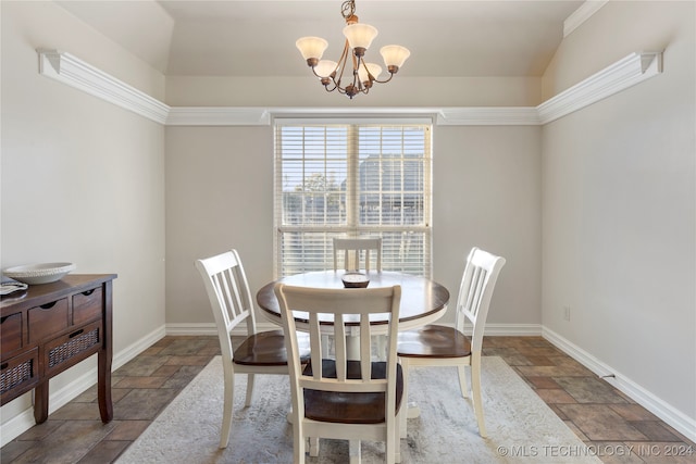 dining space with vaulted ceiling, crown molding, and a chandelier