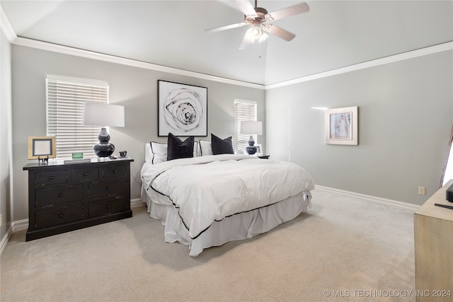 carpeted bedroom with vaulted ceiling, ceiling fan, and crown molding