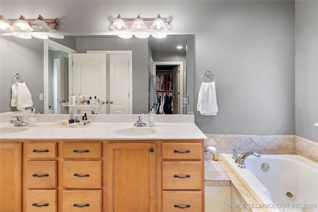 bathroom with vanity and tiled bath