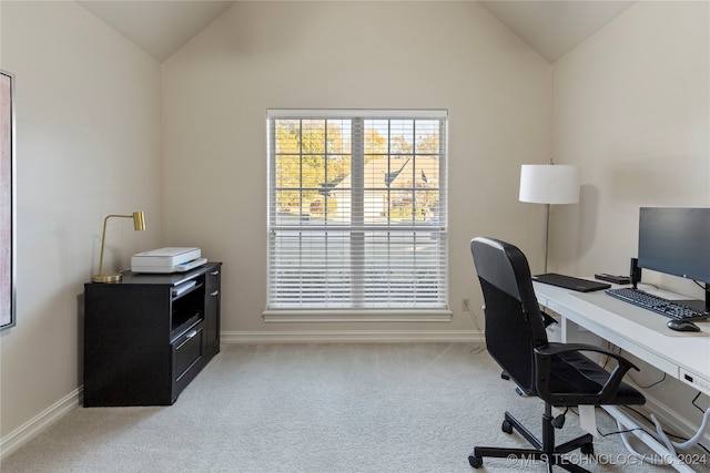 home office with light carpet and lofted ceiling