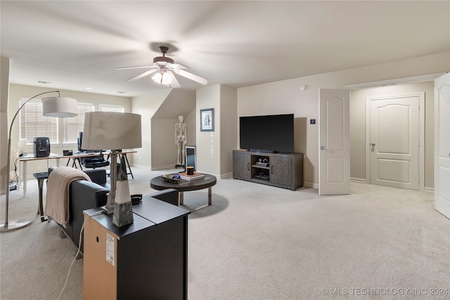 carpeted living room featuring ceiling fan