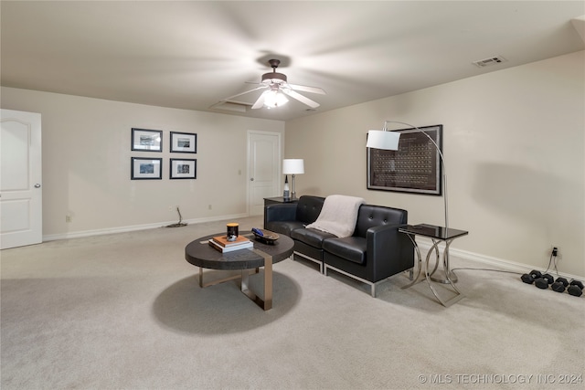 carpeted living room featuring ceiling fan