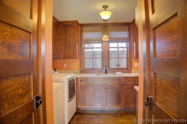 laundry room featuring cabinets, sink, and washing machine and dryer