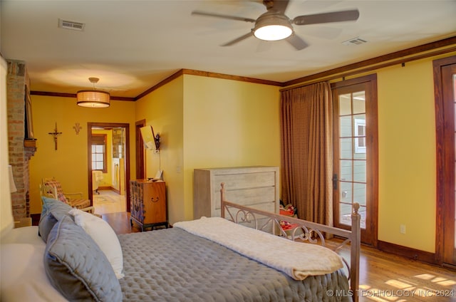 bedroom featuring ceiling fan, light hardwood / wood-style floors, and ornamental molding